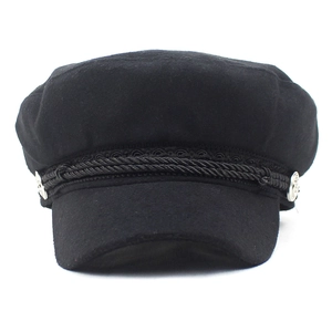 Front detail of wool newsboy hat featuring a braided rope and silver metal side buttons