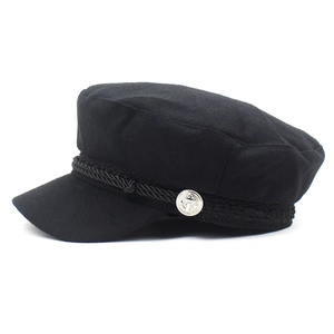 Detail of black baker boy hat with braided rope trim and silver anchor metal button