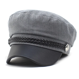 Detail of grey baker boy cap with black leather brim and decorative braided cord