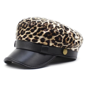 Fashion newsboy cap featuring a leopard print top and black leather brim with gold button