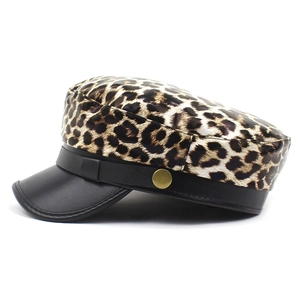Detail of leopard print newsboy cap with black PU leather visor and gold side button