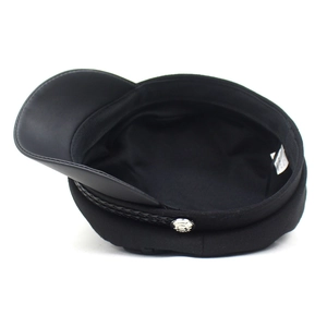Detailed interior view of a black baker boy hat with internal lining and laundry label