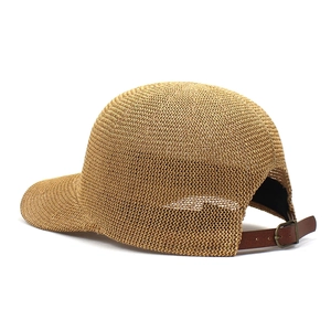 Detailed close-up of brown straw woven texture and adjustable leather back strap of the hat