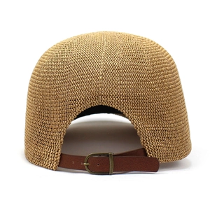 Detail of straw baseball cap back with brown leather adjustable strap and metal buckle