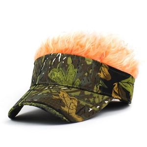 Close-up of camouflage sun visor hat featuring a bright orange fluffy novelty wig decor