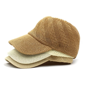 Close-up of three woven straw baseball hats in brown, beige, and khaki with breathable texture