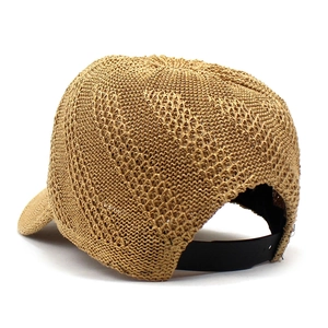 Women's light brown straw woven sun hat with adjustable strap and breathable texture