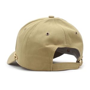 Detail of khaki cotton baseball cap with gold chain accent and adjustable rear strap