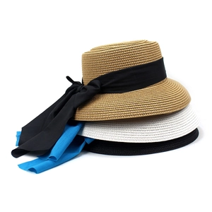 Three flat-top straw hats in khaki, white, and black with elegant ribbon bow details