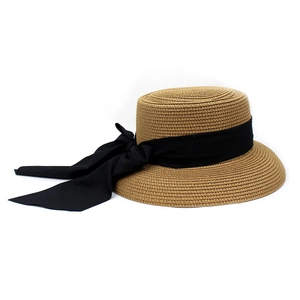 Detailed macro view of woven boater hat texture with black ribbon bow decoration