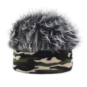 Close-up of creative camo knit beanie with grey faux fur top for winter warmth