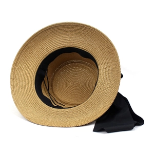 Women's wide brim straw sun hat with black ribbon bow and adjustable strap for beach