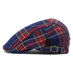 Detail shot of vintage plaid flat cap with adjustable bronze metal buckle on the side
