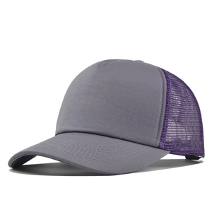 Detail of grey front panel and purple breathable mesh on two-tone trucker cap