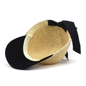 Straw baseball hat with a black brim and large decorative bow on the back