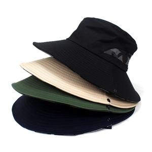 Stack of wide brim camouflage bucket hats in black, khaki, green, and navy blue