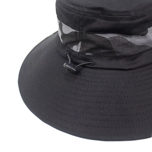 Detail of black outdoor bucket hat showing camouflage mesh band and adjustable drawstring