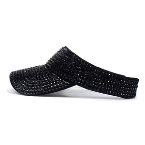 Detail of black rhinestone visor hat featuring rows of premium faceted crystals