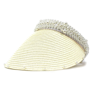 Detail of elegant straw sun hat with white pearl beads on headband and brim