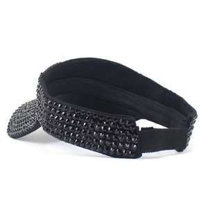 Detail of black open top sun hat featuring sparkling rhinestones and elastic strap