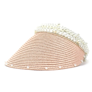 Detailed macro view of woven straw texture and elegant white pearls on the sun hat brim
