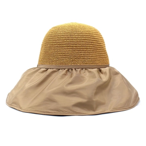 Detail view of yellow woven crown and khaki fabric brim with stylish pleated sun hat texture