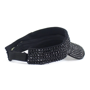 Detail view of the black rhinestone sun visor featuring an adjustable velcro strap back