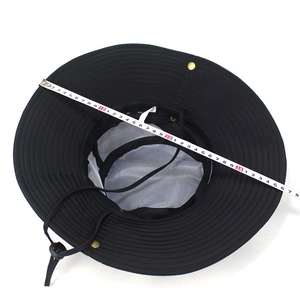 Detail of black sun hat featuring breathable mesh lining and adjustable windproof strap