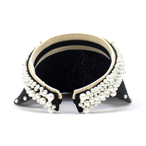 Elegant wide headband with white pearls on thin black frame for summer fashion styling