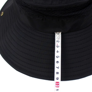 Detail shot of a 10cm wide brim on a breathable outdoor sun hat with measuring tape