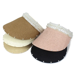 Straw sun visor hats with pearl embellishments in four colors on a white background