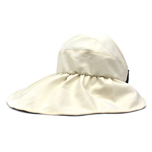 Detail view of beige wide brim sun hat showing unique pleated fabric and canvas texture