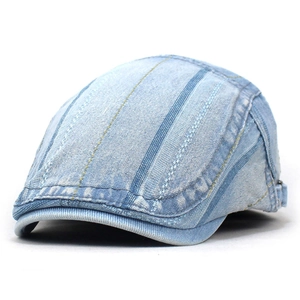 Detailed side view of washed blue denim ivy cap featuring metal buckle and stripe stitching