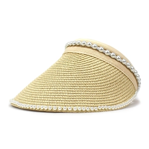 Close-up of beige woven visor with delicate white pearl trim on a white background