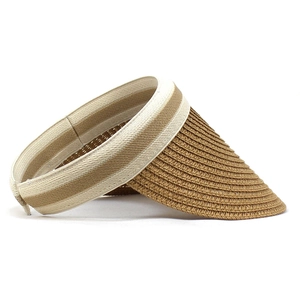Detail of woven straw texture and contrast elastic headband on wide brim sun visor
