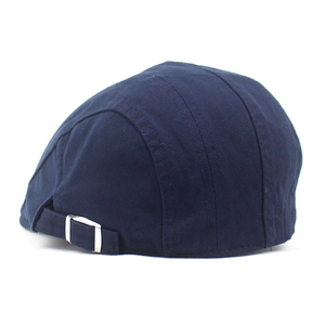 Detail of navy cotton newsboy cap with adjustable silver metal buckle on back