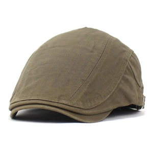 Detailed view of the tan herringbone pattern fabric and adjustable side buckle on flat cap