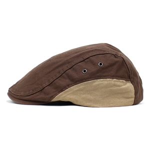 Detail view of cotton flat cap featuring metal eyelets and contrast stitching