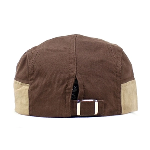 Close-up of the silver metal buckle and adjustable strap on a vintage canvas cap