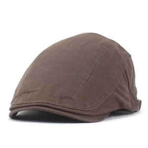 Detailed macro view of brown herringbone flat cap with adjustable side metal buckle