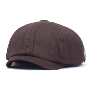 Detailed view of dark brown mesh patchwork newsboy cap fabric texture and stitching