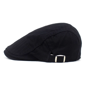 Détail de béret noir en coton avec boucle métallique et coutures sur le bord de la visière