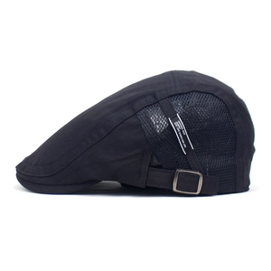 Detail of black cotton mesh flat cap showing silver metal buckle and breathable side panels