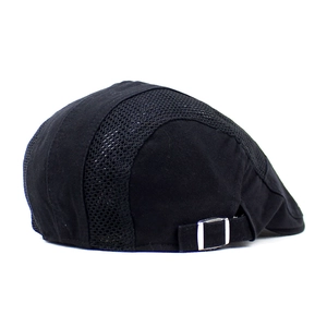 Detail of the black mesh beret showing the breathable fabric and silver metal buckle