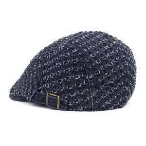 Detail view of denim ivy cap featuring distressed fabric and adjustable metal buckle
