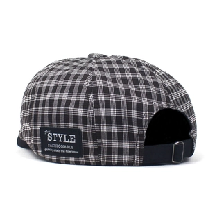 Classic black and white plaid beret cap with adjustable metal buckle and side patch