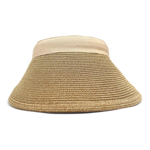 Detail of hand-woven straw texture and silky ribbon on wide brim sun visor hat