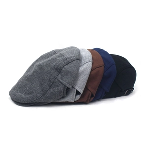 Detailed view of adjustable silver metal buckles and five classic colors of beret caps