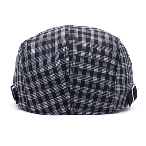 Detail view of black and white plaid ivy cap featuring an adjustable metal buckle
