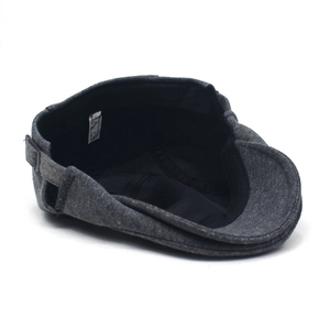 Macro shot of 100% polyester dark grey newsboy cap with metal adjustable side buckle detail
